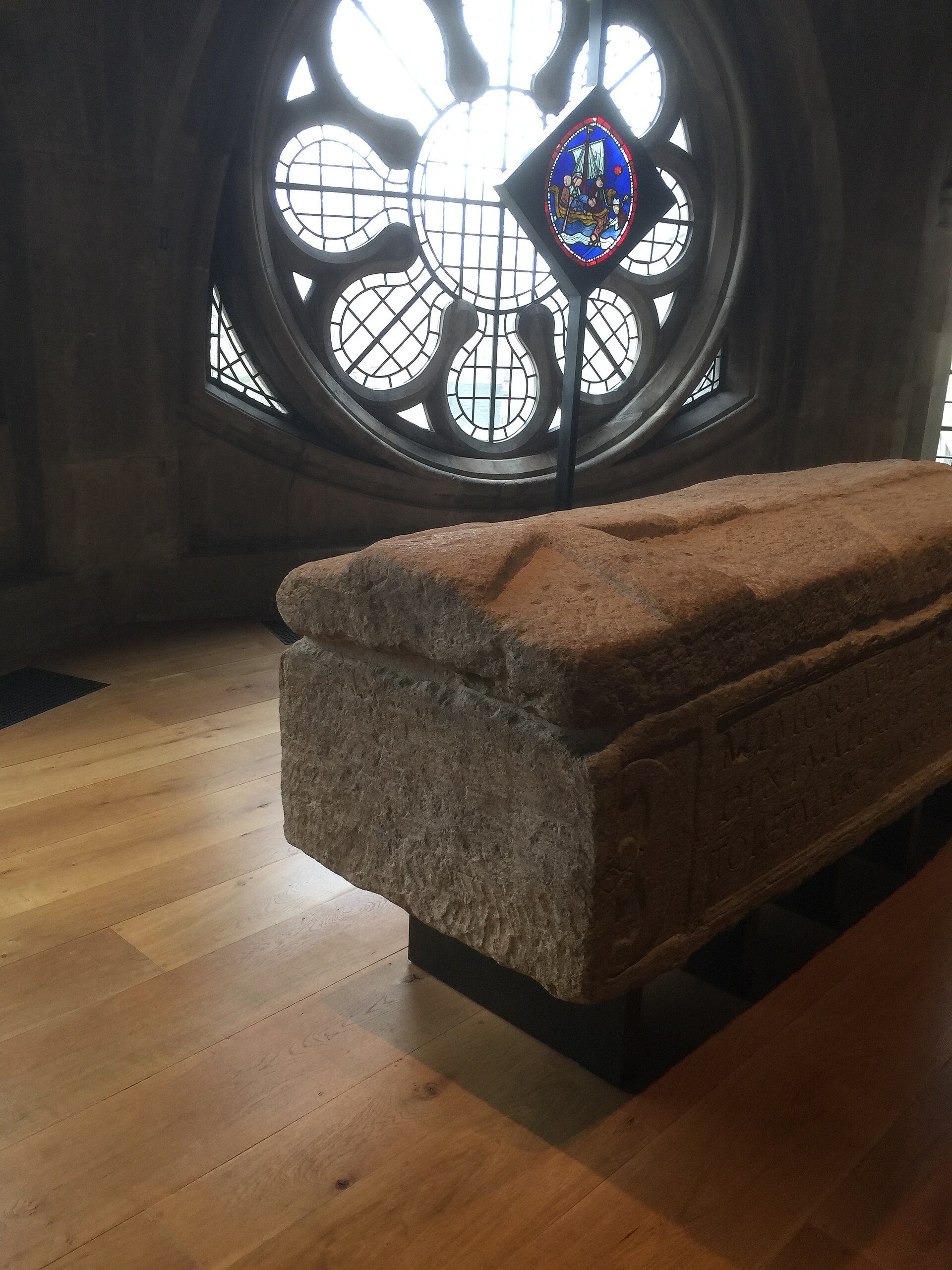 Carved Roman stone coffin in a gallery