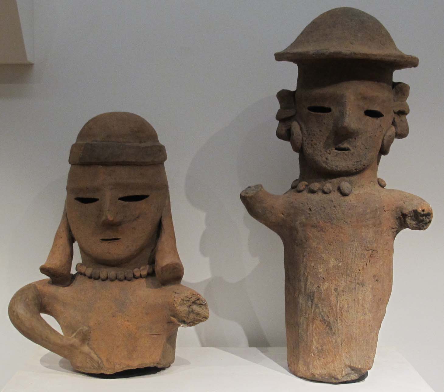 Two clay haniwa busts, male and female