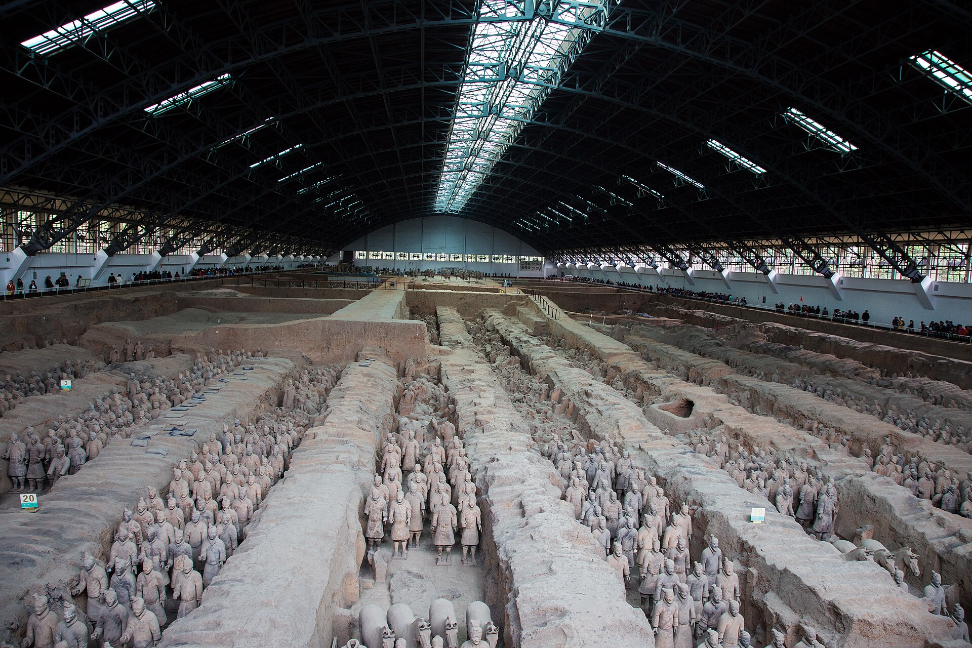 Rows of terracotta warriors standing in the long earthen corridors of Pit 1