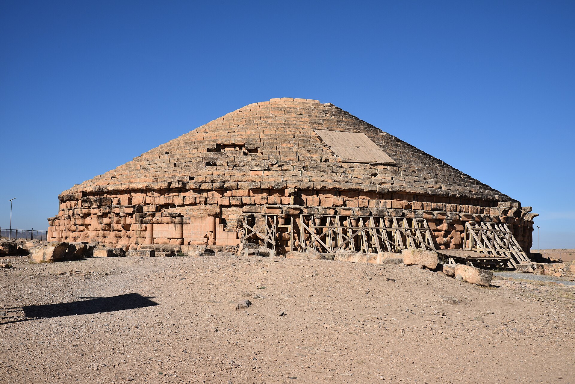Stepped conical stone mausoleum ringed by columns
