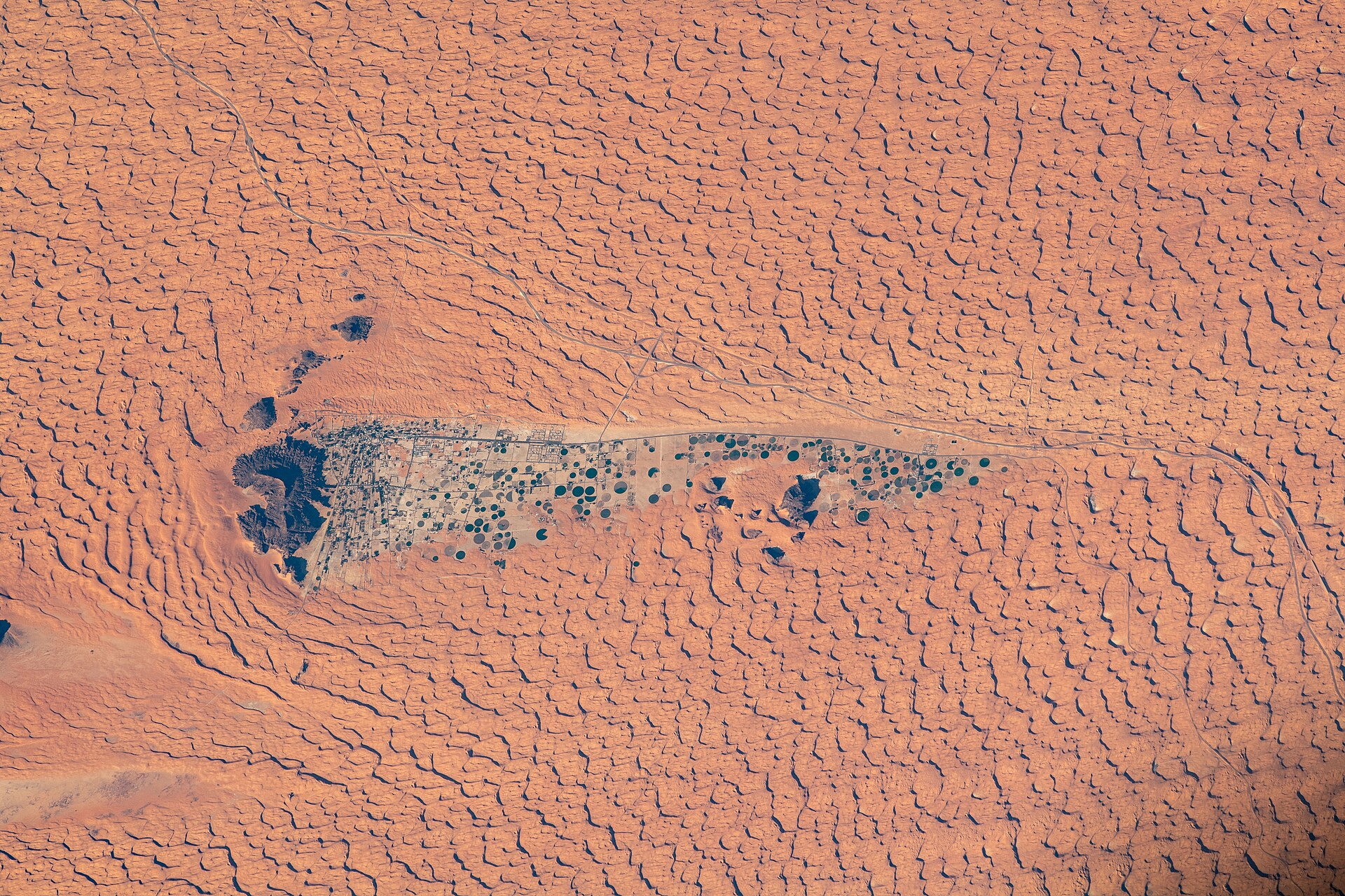 Orbital photo of Jubbah oasis amid red desert sand