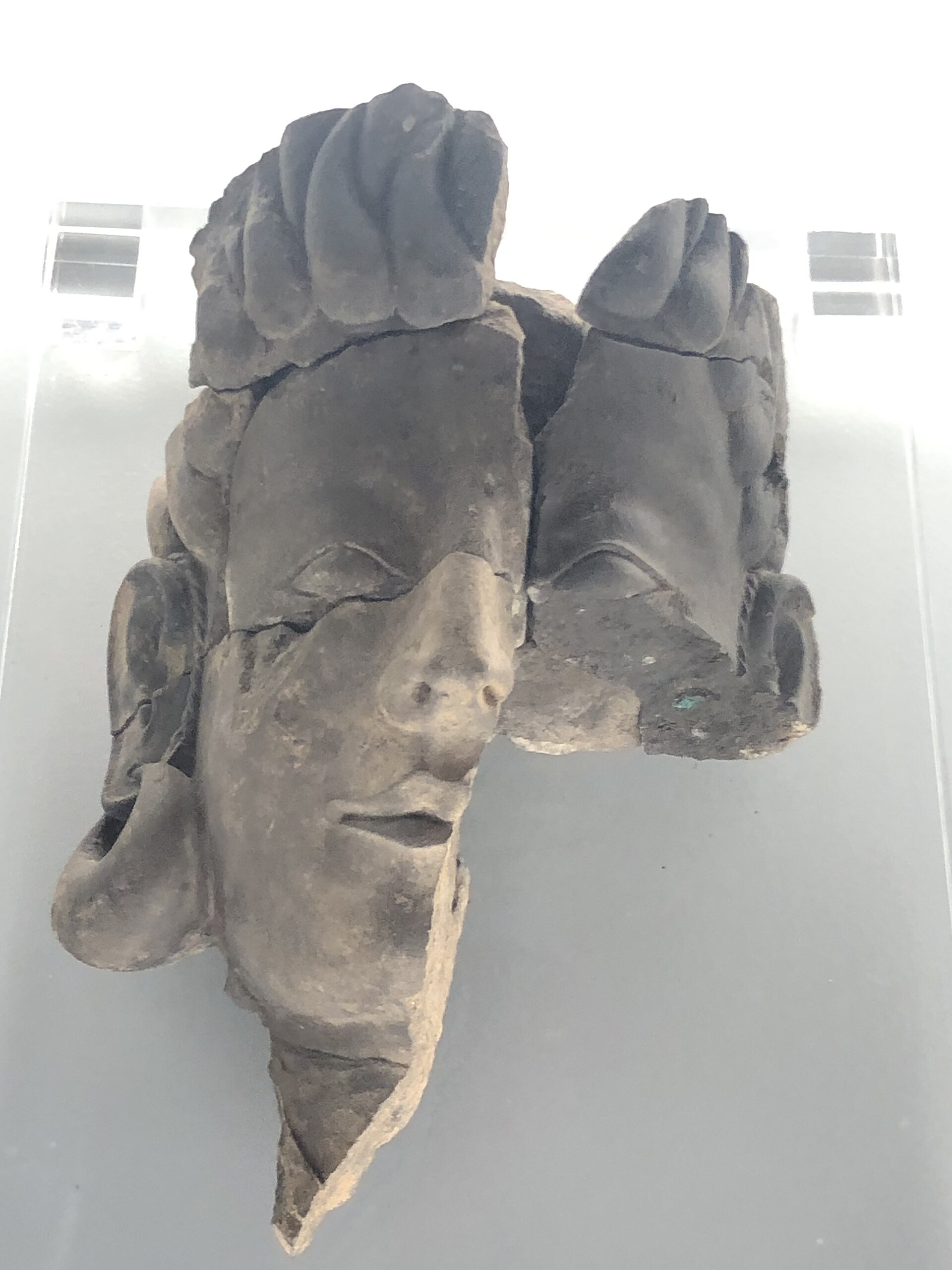 Carved stone face with large earrings from the Tartessian site of El Turuñuelo