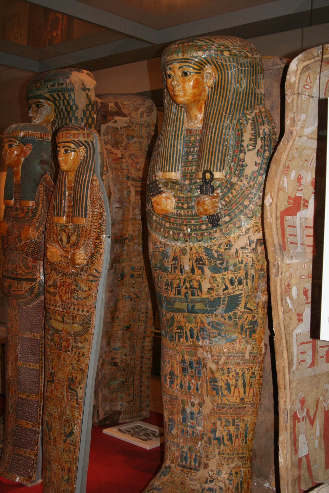 Painted Egyptian coffin in a museum gallery