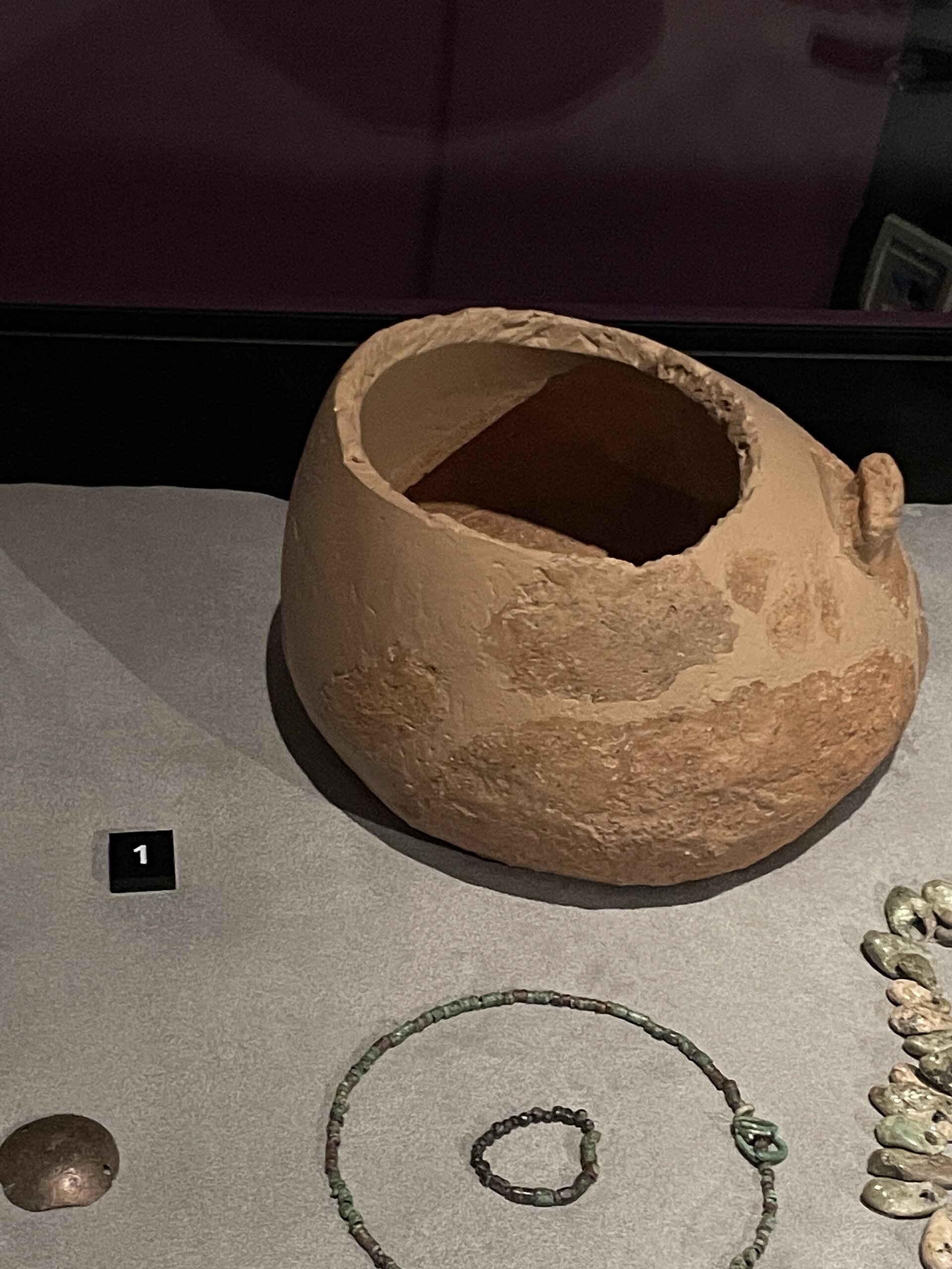 Painted Copper Age clay vessel displayed in a museum