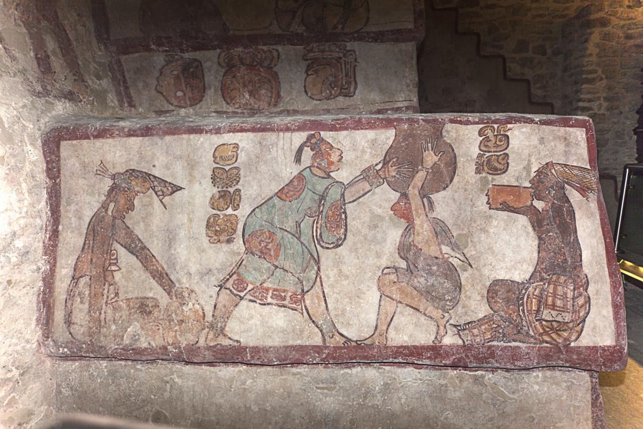 Painted Maya mural showing figures in market scenes