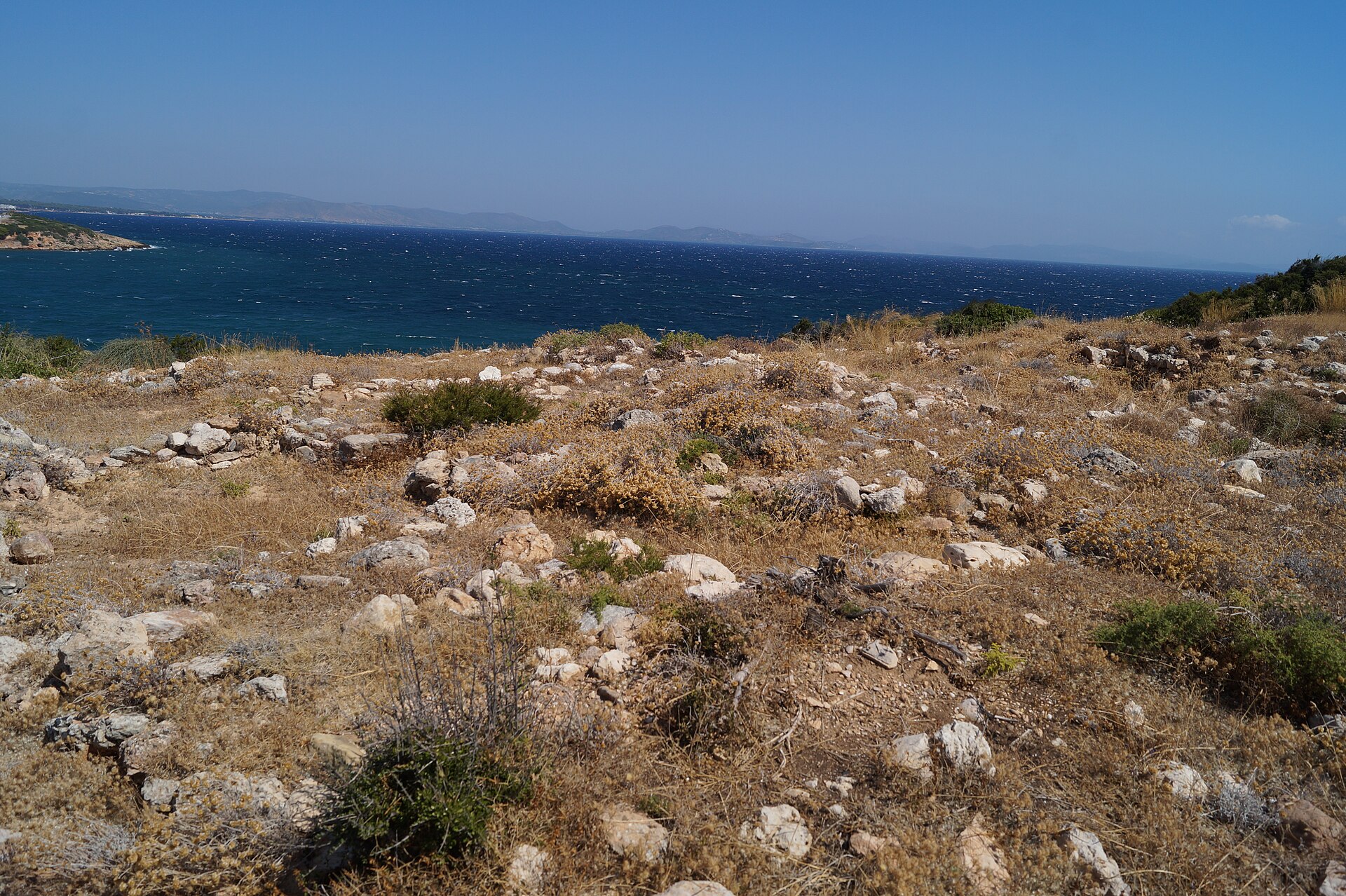 Low stone foundations of ancient houses on a rocky hillside at Askitario near Rafina