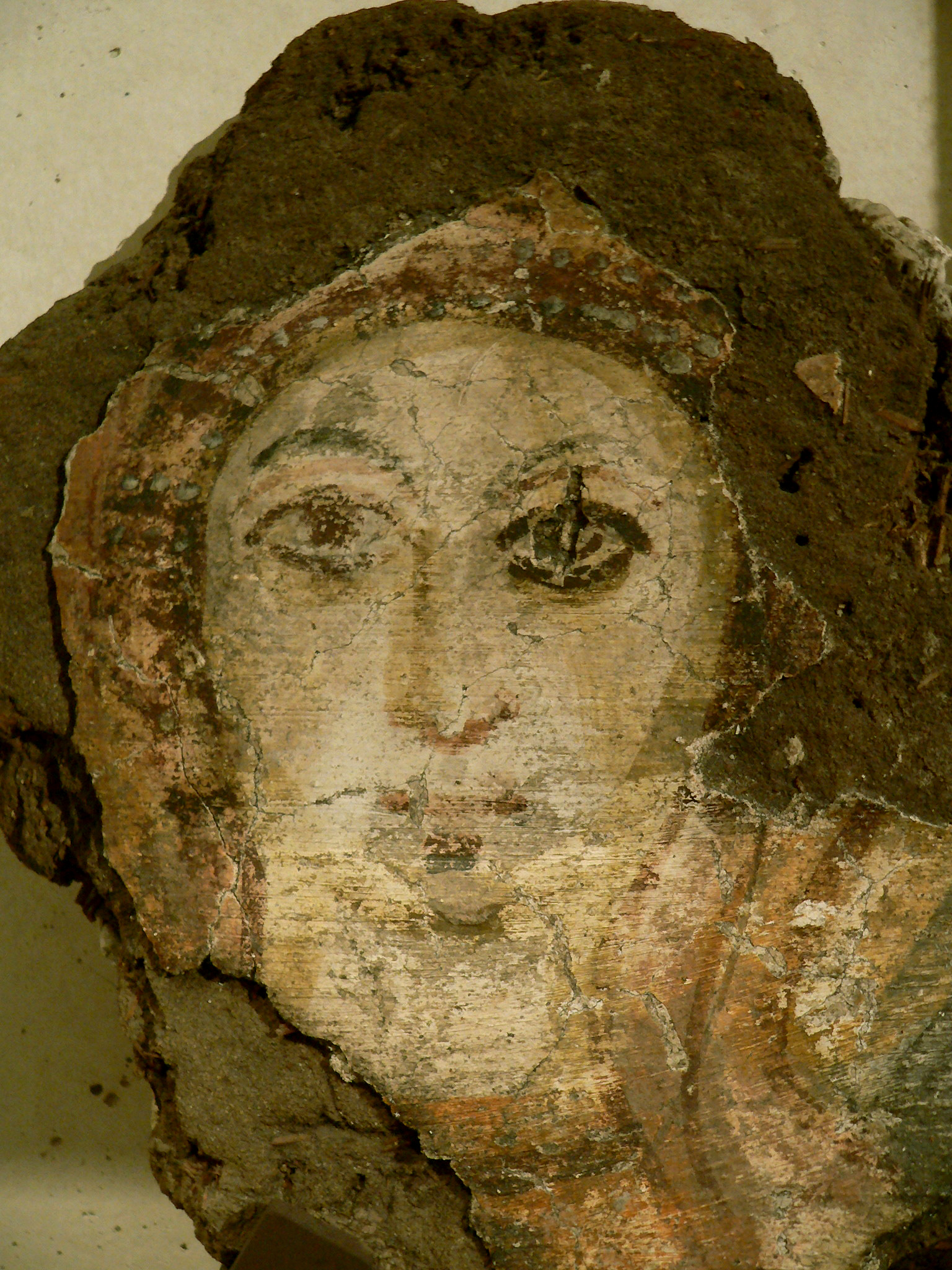 Painted fragment showing a woman's face from an early Coptic monastery