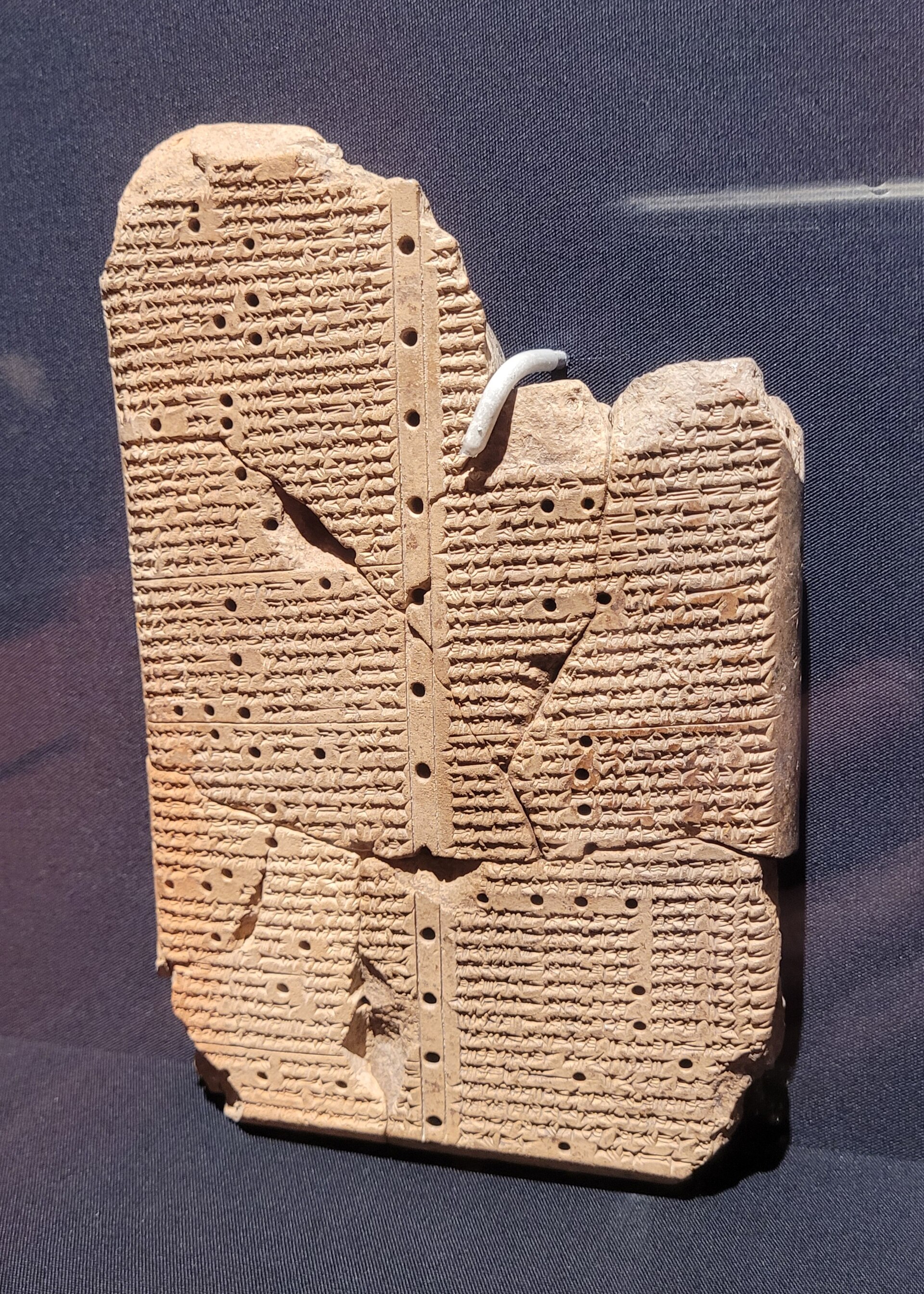 Clay tablet covered in cuneiform signs