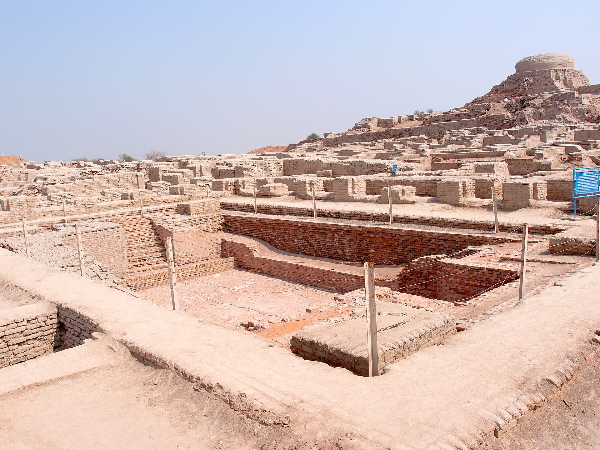 Brick ruins of the ancient Indus city of Mohenjo-daro with a large rectangular bath structure