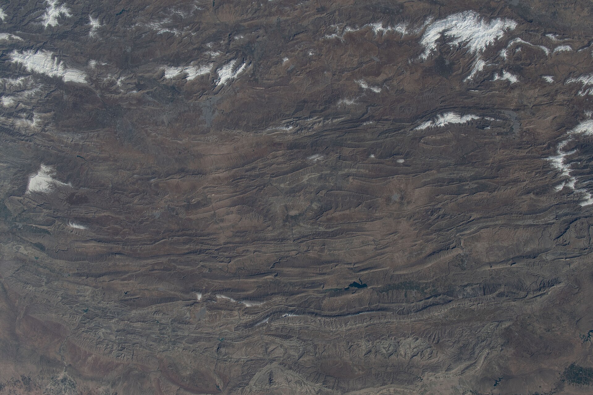 Aerial view of rocky ridges and narrow valleys in Iran's Zagros Mountains