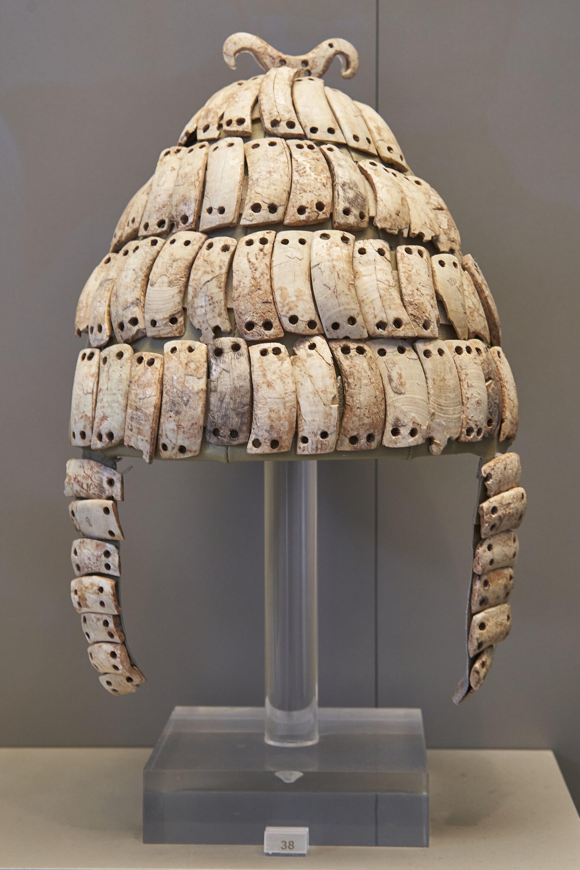 Helmet covered in rows of boar tusk plates with cheek-guards