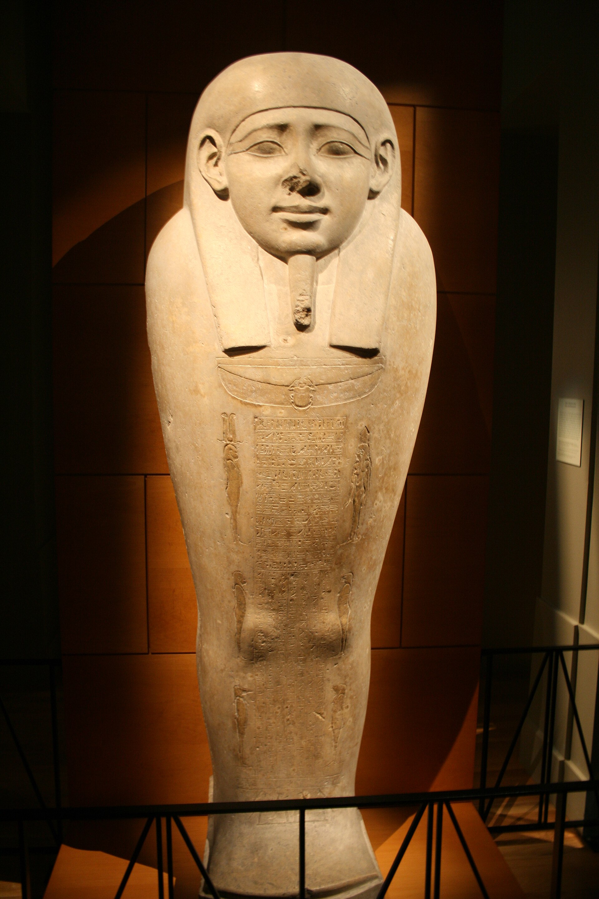 Carved limestone sarcophagus from Saqqara in a museum gallery