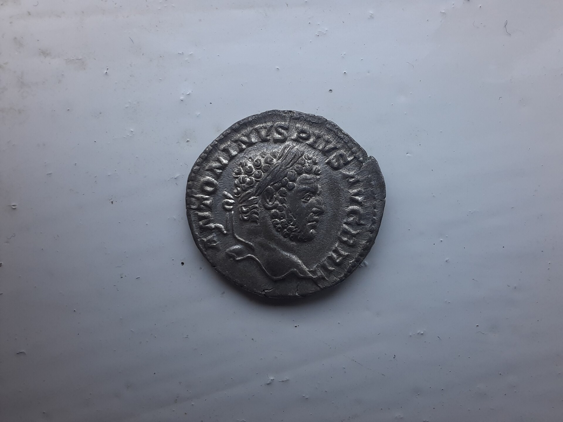 Silver Roman coin showing the head of Caracalla