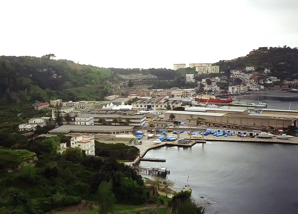 View over the bay and town of Baia with Roman ruins on a hillside