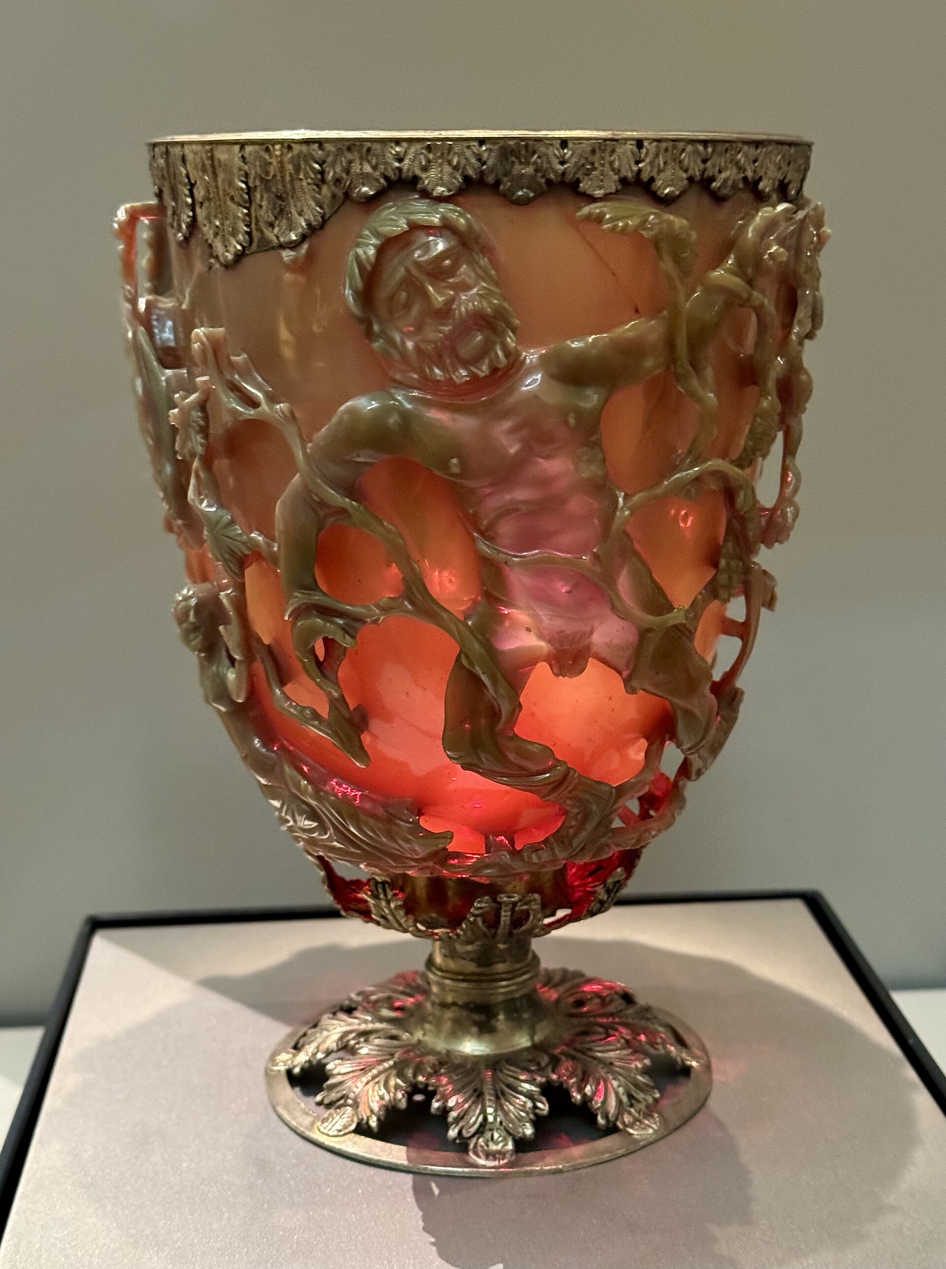 Green Roman glass cage cup with carved figures